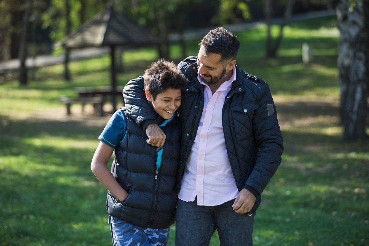 Father and son in public park