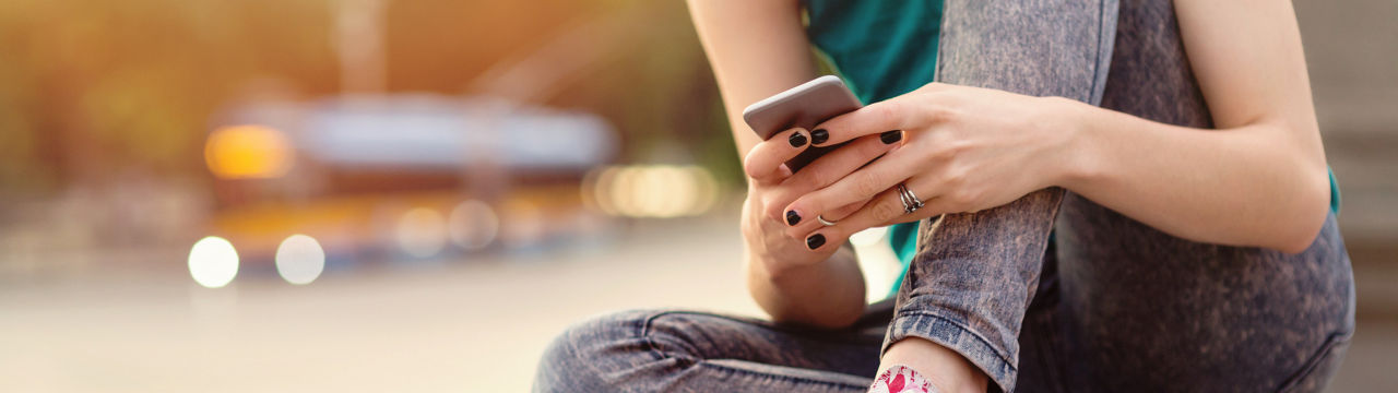 Teenage girl breaking up with her boyfriend while sitting on a bridge near big boulevard. Casual clothing with shirt and jeans